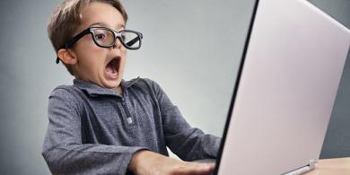 A picture of a boy in front of laptop